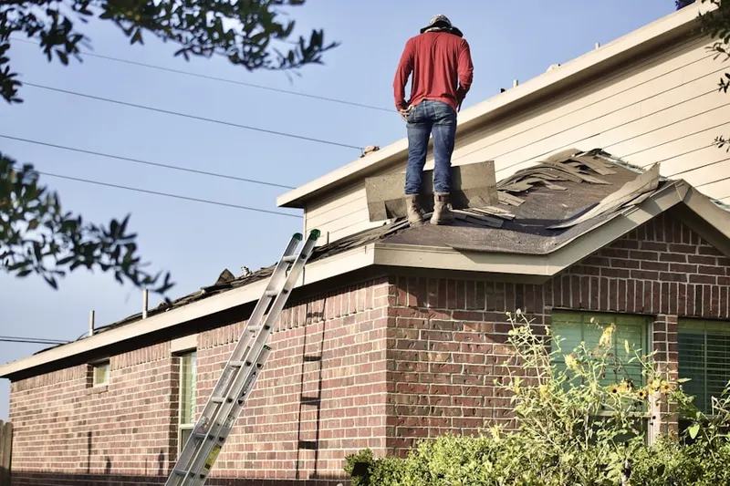 Professional roofer working on a residential roof in Gum Springs